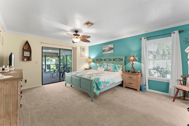 carpeted bedroom featuring access to exterior, a textured ceiling, ceiling fan, and ornamental molding