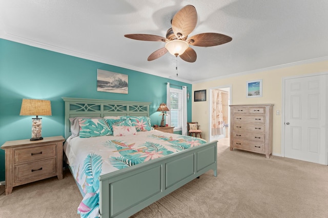 carpeted bedroom with ceiling fan, crown molding, and ensuite bath