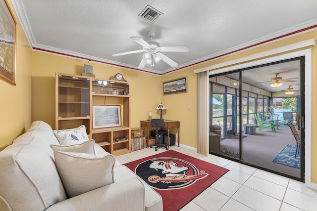 tiled living room with ceiling fan, a textured ceiling, and ornamental molding