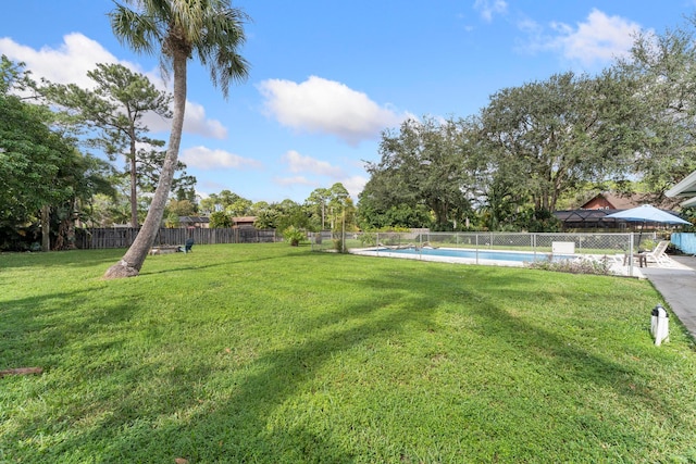 view of yard with a fenced in pool