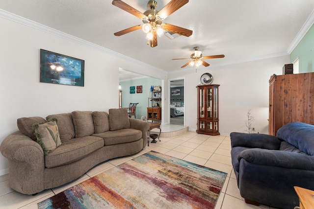 tiled living room with ceiling fan and crown molding