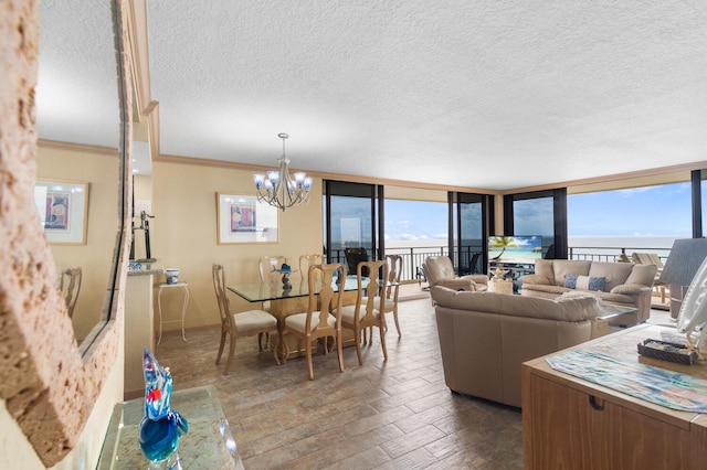 3009 S Ocean Blvd Unit 901, Highland Beach, FL 33487 - living area featuring dark wood-style floors, a chandelier, a textured ceiling, baseboards, and crown molding