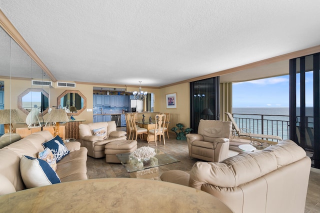 3009 S Ocean Blvd Unit 901, Highland Beach, FL 33487 - living room with a chandelier, a textured ceiling, a water view, plenty of natural light, and ornamental molding