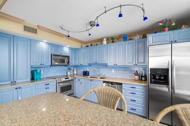 3009 S Ocean Blvd Unit 901, Highland Beach, FL 33487 - kitchen featuring stainless steel appliances, a sink, blue cabinets, rail lighting, and tasteful backsplash