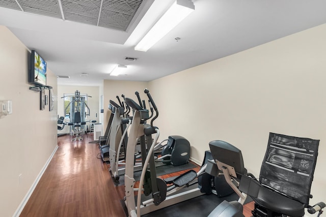 workout area featuring dark hardwood / wood-style flooring