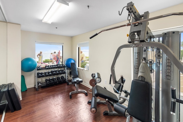 3009 S Ocean Blvd Unit 901, Highland Beach, FL 33487 - workout room featuring baseboards, healthy amount of natural light, and wood finished floors