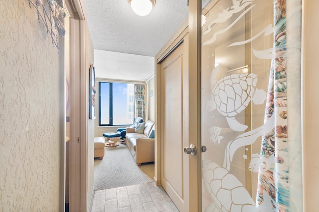3009 S Ocean Blvd Unit 901, Highland Beach, FL 33487 - corridor featuring a textured ceiling and light wood finished floors