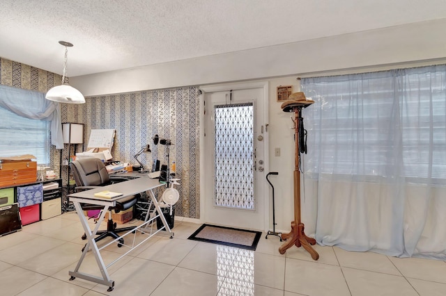 tiled entryway with a textured ceiling