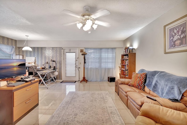 tiled living room featuring a textured ceiling and ceiling fan