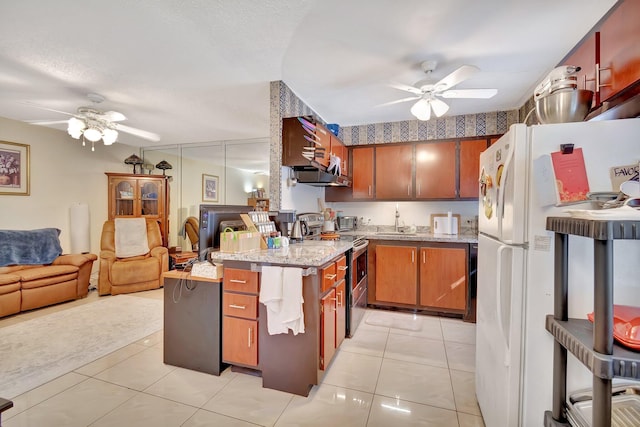 kitchen featuring sink, white refrigerator, a textured ceiling, stainless steel electric stove, and light tile patterned floors