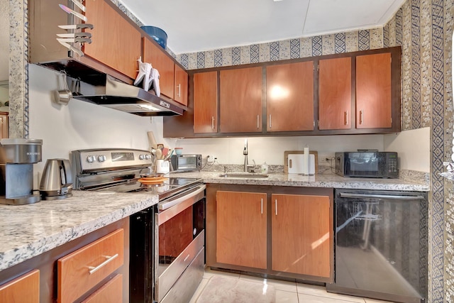 kitchen featuring light stone counters, ventilation hood, sink, black appliances, and light tile patterned floors