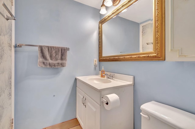 bathroom with tile patterned flooring, vanity, and toilet