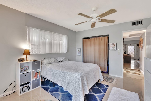 tiled bedroom with ceiling fan