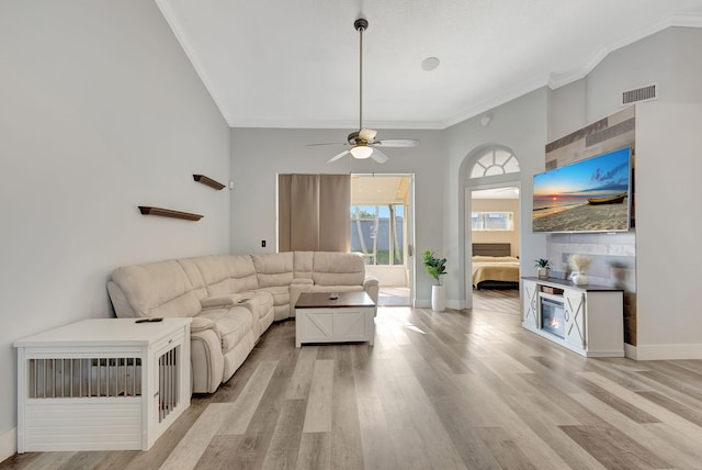 living room featuring crown molding, light hardwood / wood-style flooring, and ceiling fan