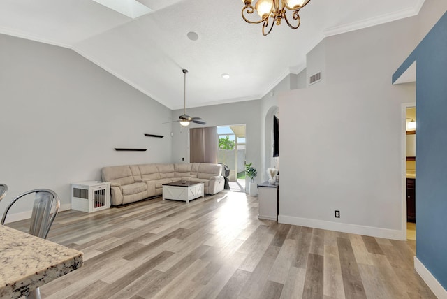 living room featuring ceiling fan with notable chandelier, light wood-type flooring, crown molding, and lofted ceiling