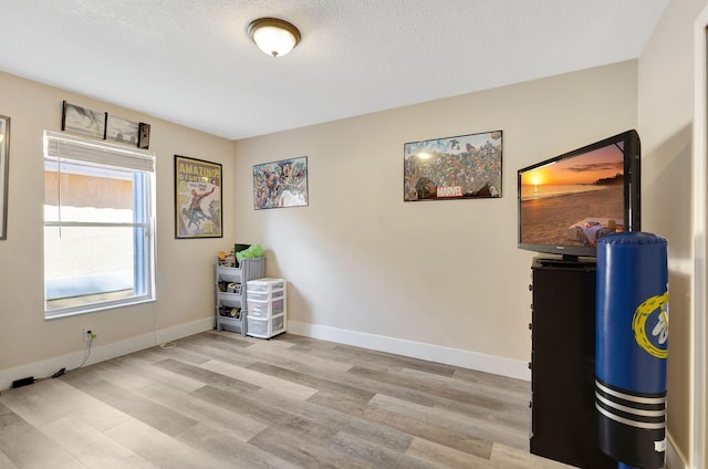 interior space featuring a textured ceiling and light hardwood / wood-style flooring