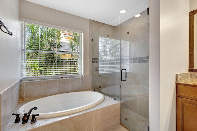 bathroom featuring separate shower and tub and vanity