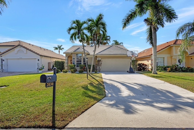 view of front of property with a garage and a front lawn