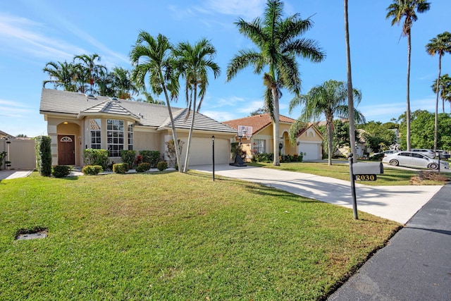 ranch-style home featuring a garage and a front lawn