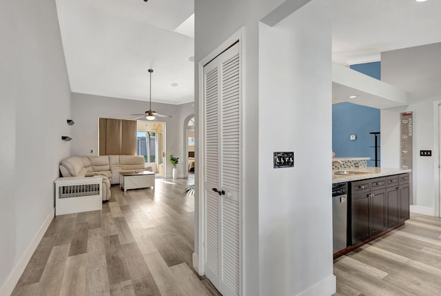 hall featuring light hardwood / wood-style flooring, ornamental molding, and sink