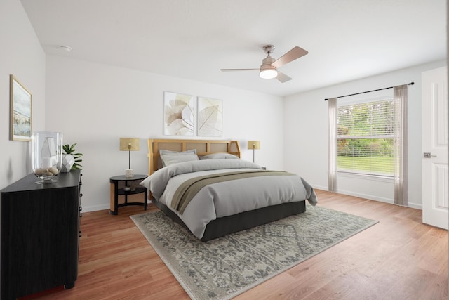 bedroom with light wood-type flooring and ceiling fan