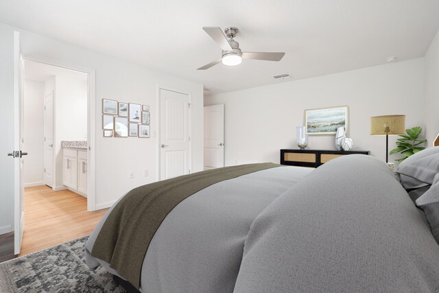 bedroom featuring light wood-type flooring, ceiling fan, and ensuite bath