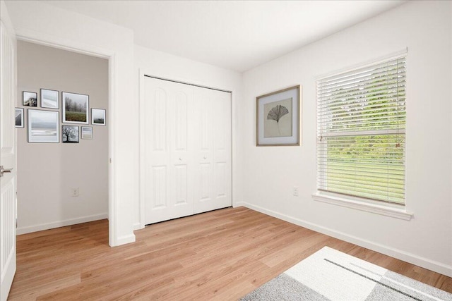 bedroom featuring a closet and light hardwood / wood-style floors