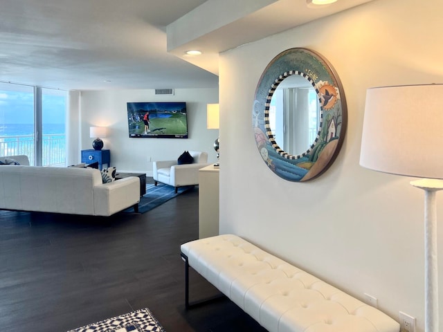 interior space featuring a water view and dark wood-type flooring