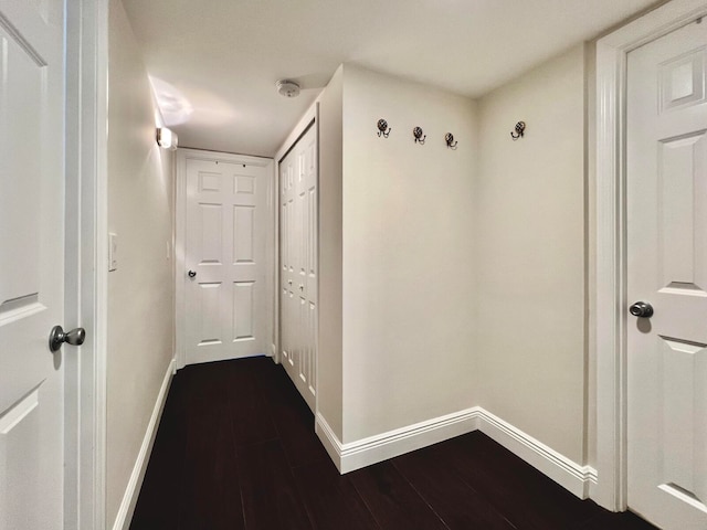 hallway with dark hardwood / wood-style floors