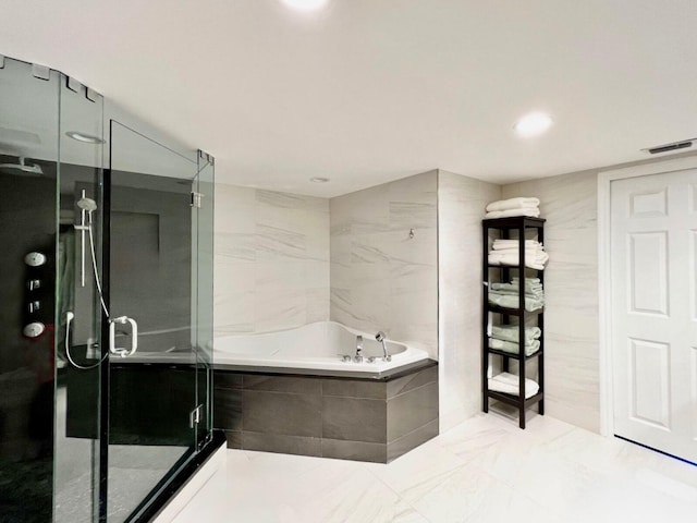 bathroom featuring independent shower and bath and tile walls