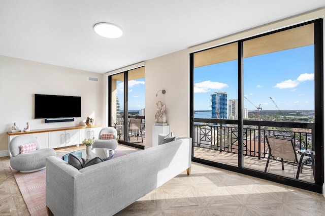 living room with expansive windows and light parquet flooring