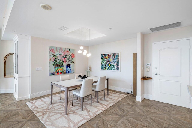 dining space with parquet floors