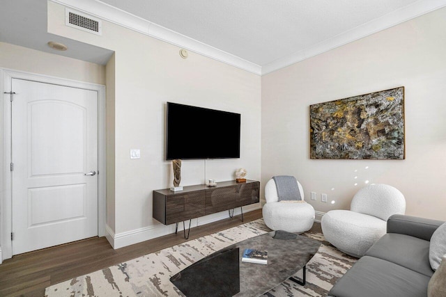 living room featuring dark hardwood / wood-style flooring and ornamental molding