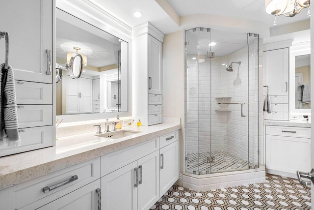 bathroom with vanity and a shower with shower door