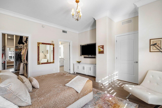 bedroom with a spacious closet, ensuite bathroom, hardwood / wood-style floors, a closet, and ornamental molding