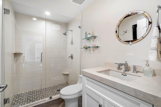 bathroom with walk in shower, toilet, vanity, and hardwood / wood-style flooring