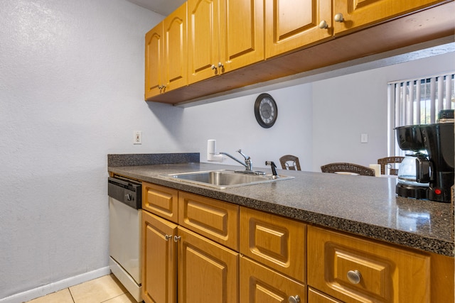 kitchen with light tile patterned floors, sink, and dishwasher