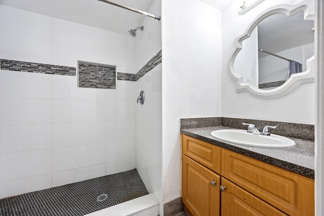 bathroom with vanity and tiled shower