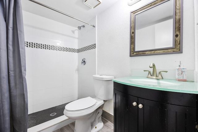 bathroom with toilet, a shower with curtain, vanity, and wood-type flooring