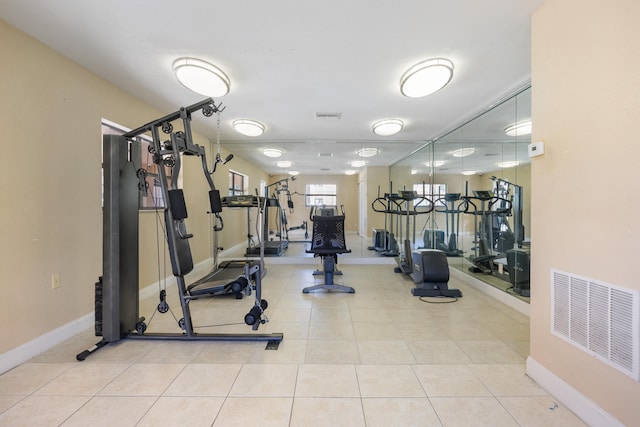 exercise room with light tile patterned flooring