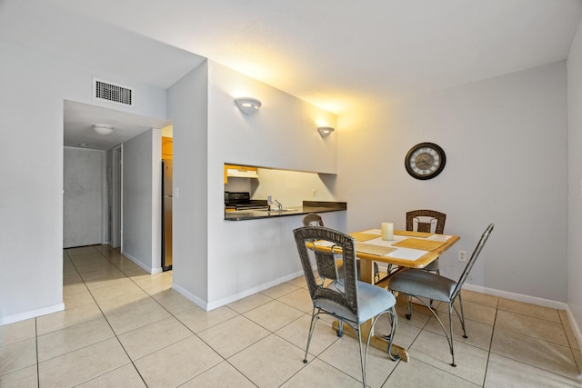 dining space featuring light tile patterned floors