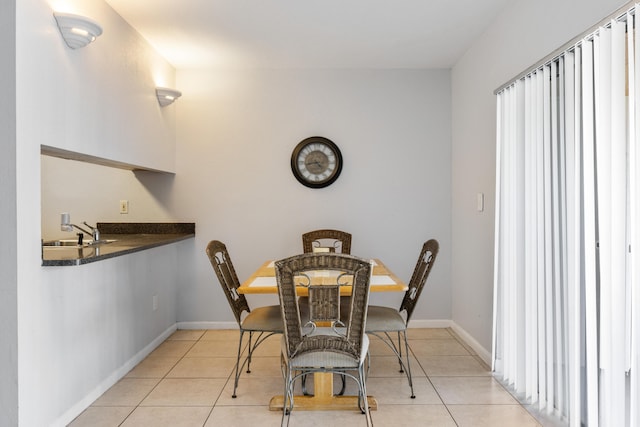 dining room with sink and light tile patterned flooring