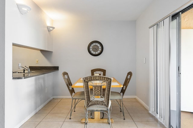 dining area with light tile patterned floors and sink