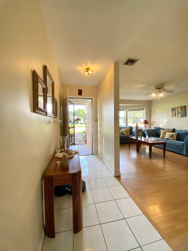 living room with ceiling fan and light hardwood / wood-style floors