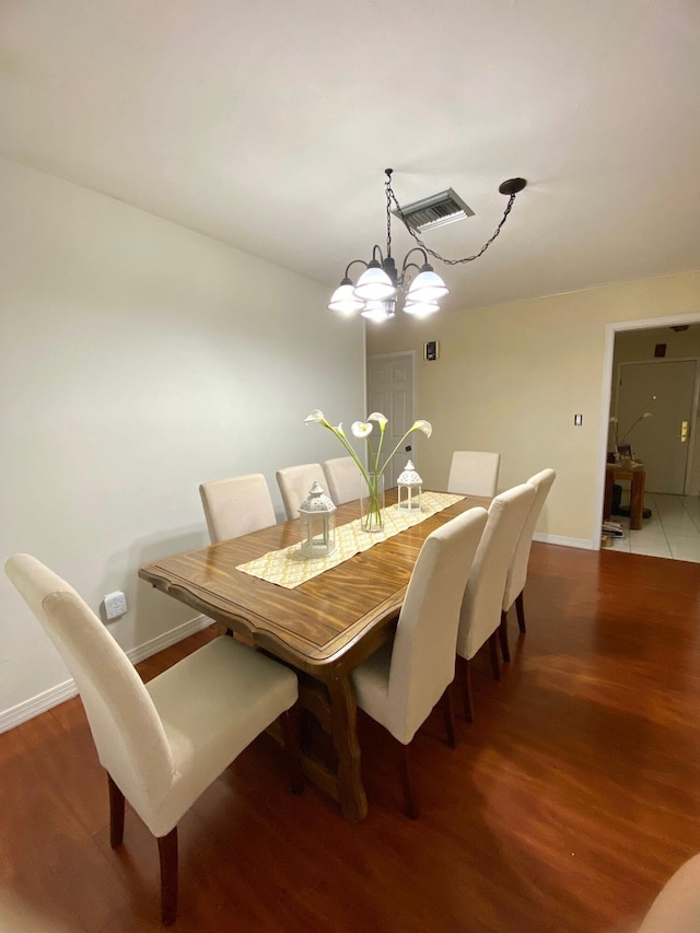 kitchen featuring light tile patterned floors, a chandelier, butcher block countertops, white cabinetry, and hanging light fixtures