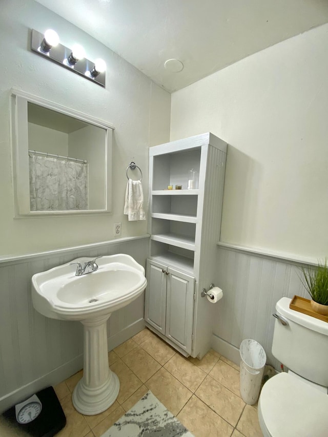 bathroom featuring toilet and tile patterned floors