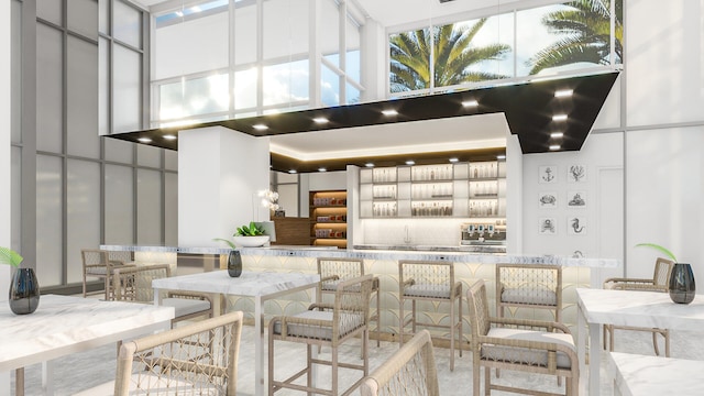 220 Lake Shore Dr Unit 1013, Lake Park, FL 33403 - interior space featuring a high ceiling, wall chimney exhaust hood, and tasteful backsplash