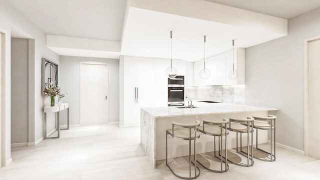 220 Lake Shore Dr Unit 1013, Lake Park, FL 33403 - kitchen with wall oven, decorative backsplash, a peninsula, a kitchen breakfast bar, and white cabinets