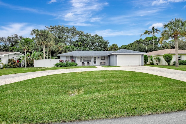 ranch-style home with a front yard and a garage