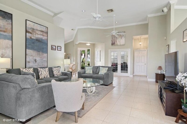 living room featuring a high ceiling, ceiling fan, french doors, and ornamental molding